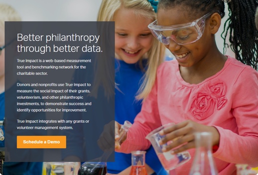 Screenshot of True Impact platform that shows two smiling school-aged girls doing a science experiment. A text overlay describes