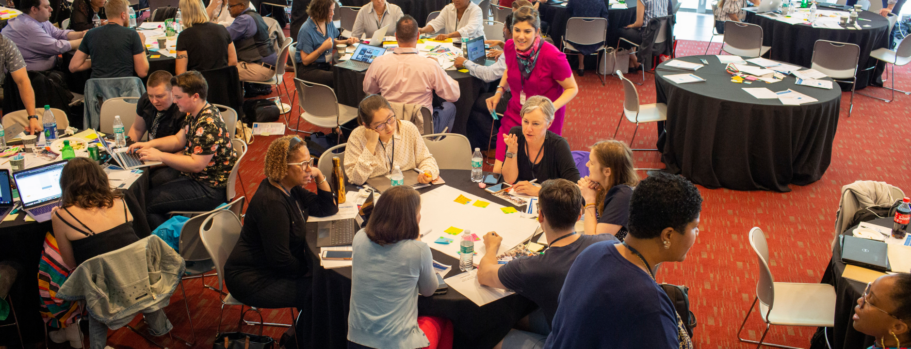 Seated women discussing ideas at a user engagement workshop hosted by The Opportunity Project