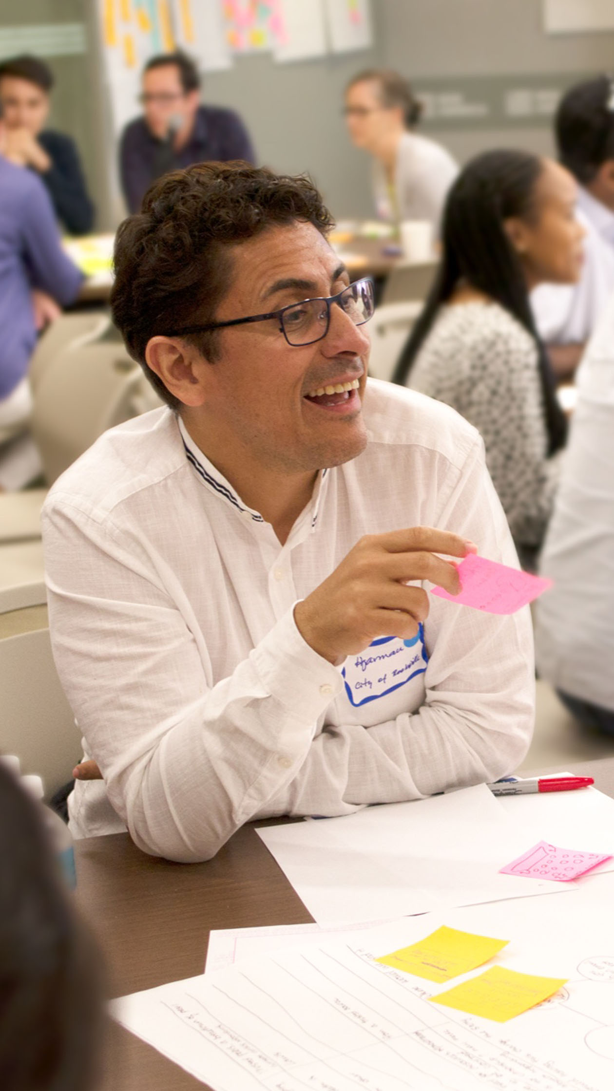 Image of a man at a table with sticky notes