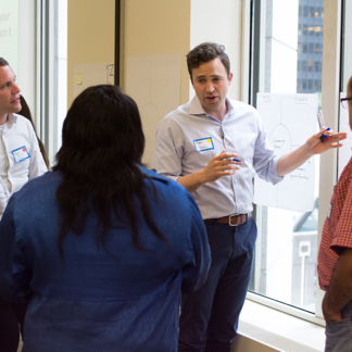 group of four people in conversation