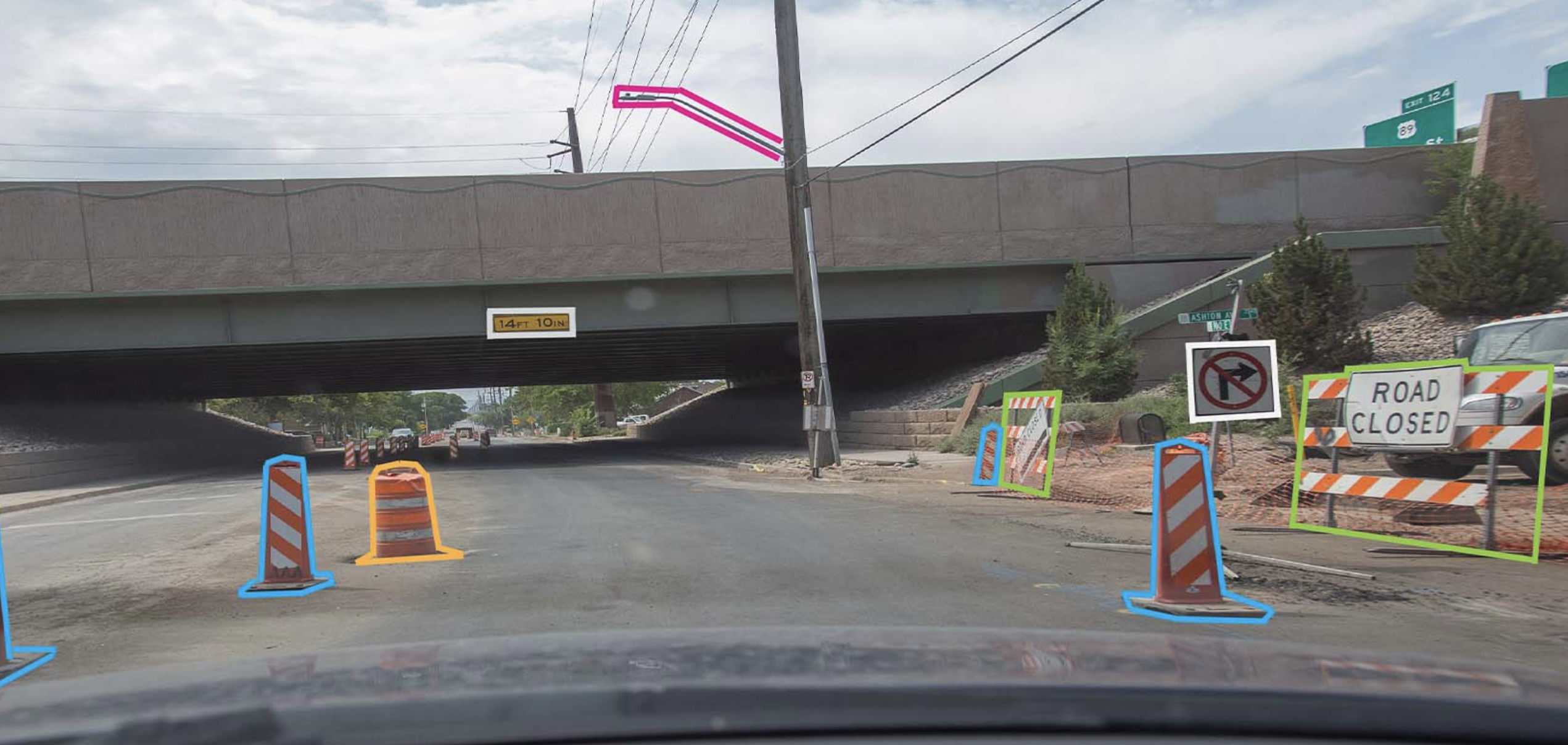 An image showing traffic cones and road closed signs highlighted in bright colors.